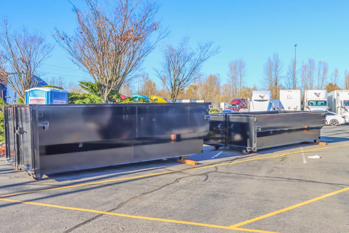 Professional dumpster rental service with roll-off container on residential driveway in Marana
